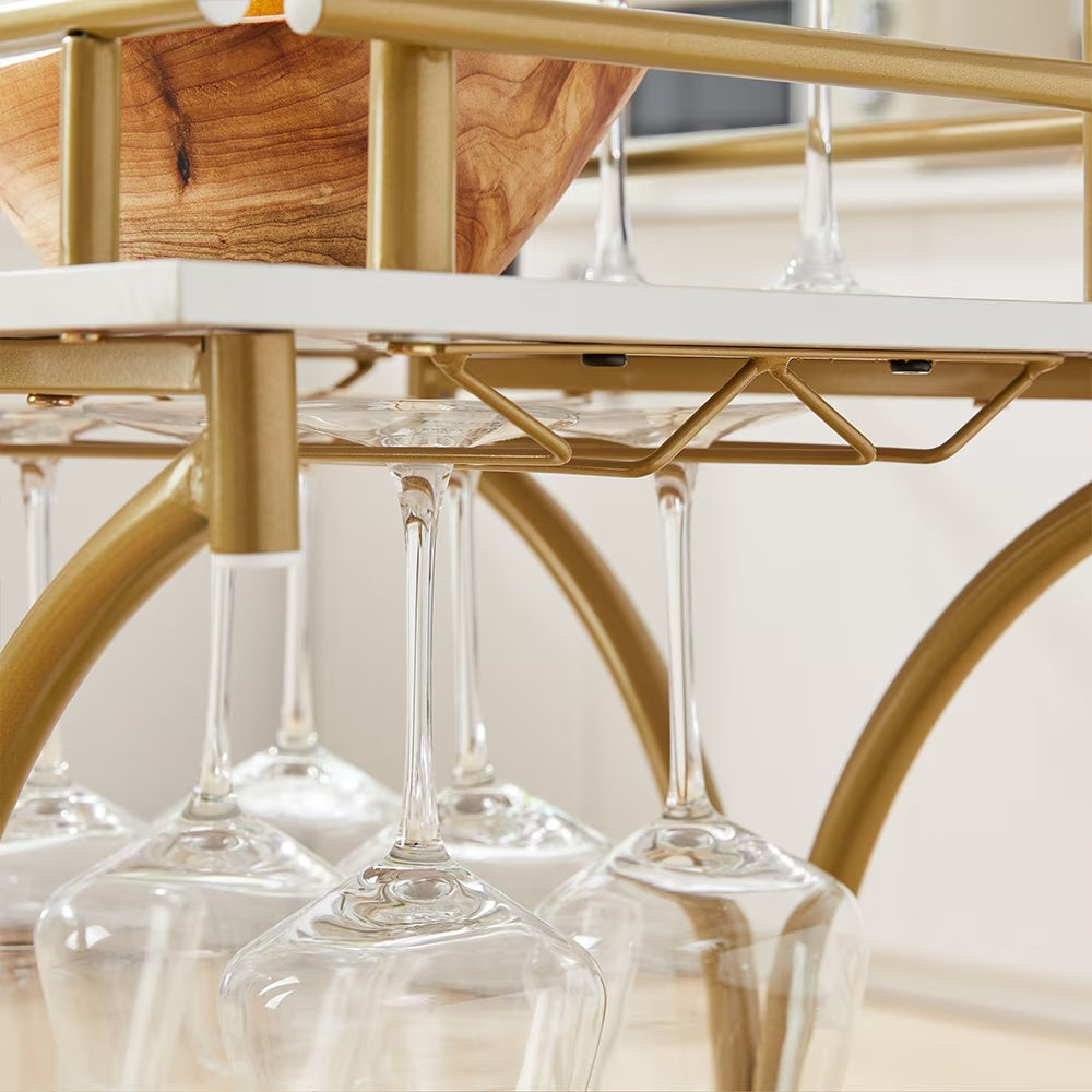 A Golden Wine Cart With Glass Shelves On The 2nd Floor Bar